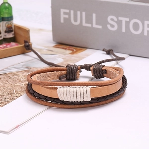 Detail of multi-layer woven leather bracelet featuring brown and coffee braided rope