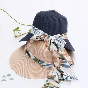 Detailed close-up of woven straw hats featuring floral ribbons and elegant wide brims