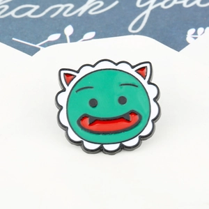 Detail of cartoon green metal badge with red ears on a decorative thank you card