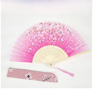 Close-up of pink cherry blossom silk fan with purple floral sleeve and soft pink silk tassel