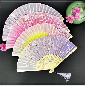 Group of four vintage silk folding fans with floral patterns and delicate tassels