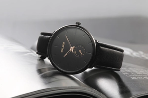 Detailed close-up of a YOLAKO watch featuring a black dial and rose gold sub-dial
