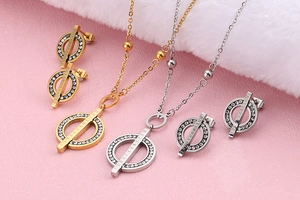 Detailed view of gold and silver jewelry set with Roman numerals and crystals