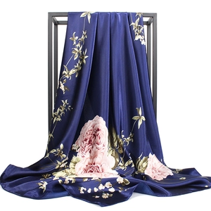 Elegant navy blue satin silk scarf with pink peony floral print on display stand
