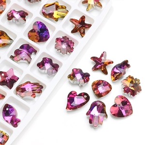 Close-up of assorted crystal glass pendants in heart and star shapes for DIY jewelry