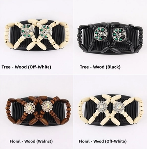 Detail view of wood beaded magic hair combs with decorative tree and flower patterns