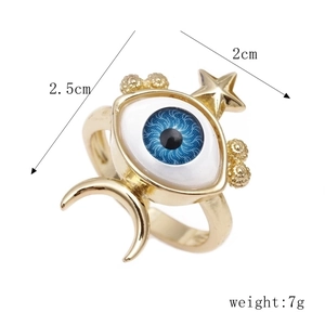 Gold-plated evil eye ring with moon and star accents on a clean white background