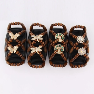 Detail of beaded magic hair combs featuring butterfly and dragonfly charms on white background