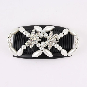 Detail view of dragonfly hair comb with white faux pearls and sparkling rhinestones