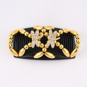 Detail of beaded magic hair comb with golden beads and colorful rhinestone dragonflies