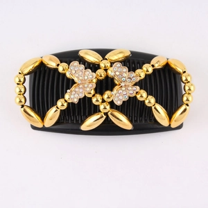 Close-up of golden butterfly beads and sparkling rhinestones on the magic hair comb
