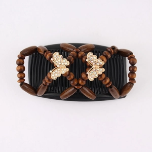 Detail of wooden beads and gold butterfly accents with rhinestones on a magic hair comb