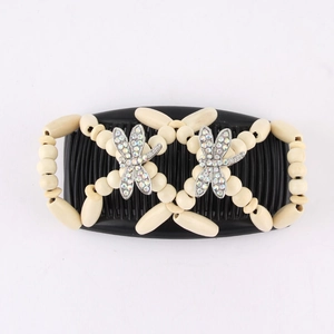 Detail of beaded magic hair comb featuring beige wooden beads and rhinestone dragonfly charms
