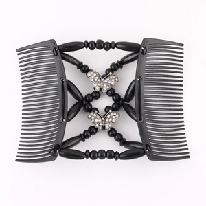 Detail of magic hair comb with black beads and sparkling silver butterfly accents