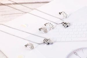 Detailed view of silver Hamsa Hand and Tree of Life necklace and earring jewelry sets