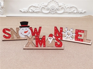 Detailed view of wooden Christmas desk signs featuring Snowman, Santa, and Snowflake patterns