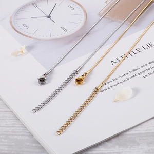 Vintage bird eye jewelry set with delicate gold and silver necklaces on an open magazine
