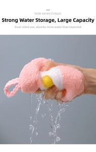 Macro shot of pink fried egg shaped hand towel absorbing water and squeezing out droplets