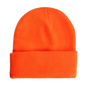 Detail view of bright orange knit beanie showing fine ribbed texture and folded cuff edge