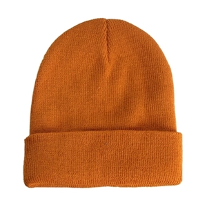 Detail shot of vibrant orange knitted beanie featuring dense fine texture and ribbed edge