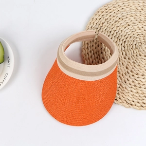 Detailed macro view of orange woven straw sun hat with wide brim and open top