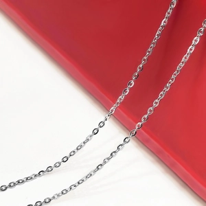 Detailed view of polished S925 sterling silver O-chain necklace on red and white background