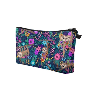 Detailed close-up of sloth and floral digital print on a navy blue rectangle makeup bag
