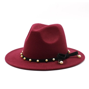 Detail view of burgundy wool fedora with pearl bead chain and black grosgrain bow