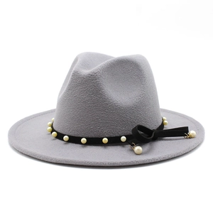 Close-up of grey fedora hat with black ribbon, elegant pearls and a bow detail