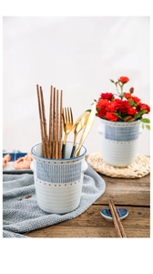 Japanese style hand-painted ceramic storage holder used as a utensil caddy or mini flower pot