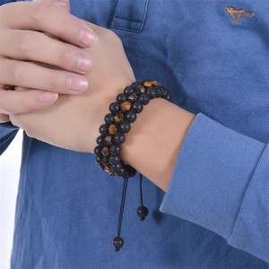 Mens double-layer bracelet with black lava rock and golden tiger eye beads on wrist