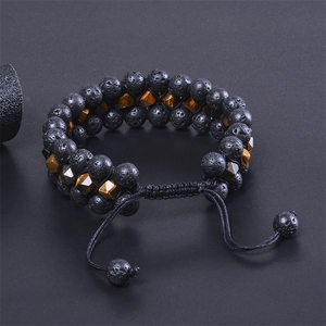 Detail of adjustable triple-layer lava rock and tiger eye stone braided bracelet