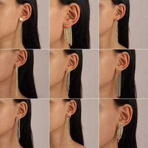 Detailed grid of nine elegant gold tassel earrings with rhinestone accents on a model