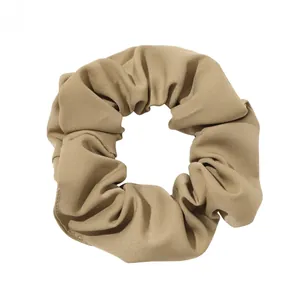 Detail shot of khaki twill fabric scrunchie with soft pleats and thick texture