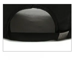 Detail of adjustable metal buckle and breathable fabric on black baseball cap