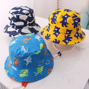Close-up of children's cotton sun hats featuring whale, bear, and shark digital prints