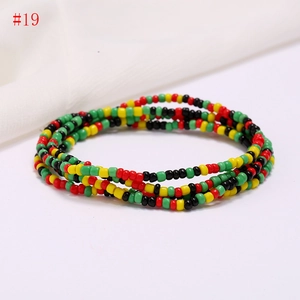 Detailed view of layered handmade multi-color seed bead body chain in boho style
