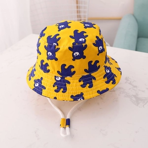 Detail of yellow kids bucket hat with blue bear print and white adjustable chin strap