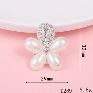 Detailed view of white pearl flower accessory with rhinestones measuring 32mm and 29mm