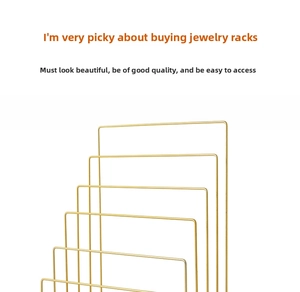 Detailed close-up of a multi-tier golden metal jewelry stand with a minimalist design