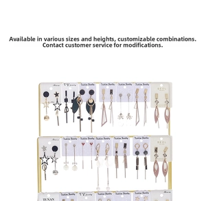 Detailed view of gold multi-tier earring display stand with white jewelry cards