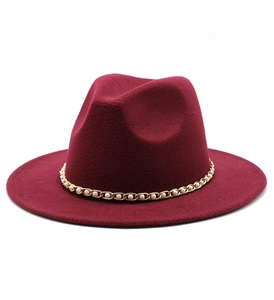 Close-up of a burgundy wool felt hat featuring an elegant gold pearl chain decoration