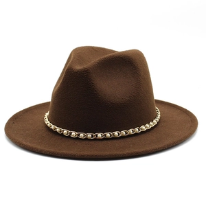 Detail of dark brown wool fedora hat featuring a gold chain and faux pearl decoration