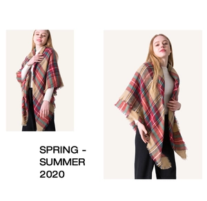 Detail of red and green plaid cashmere scarf featuring soft fringes and large wrap style