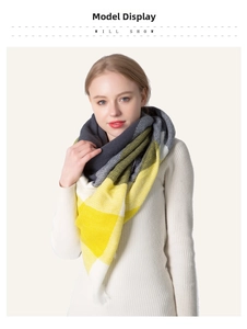 Close-up of yellow and grey plaid cashmere-like scarf showing soft texture and fringes