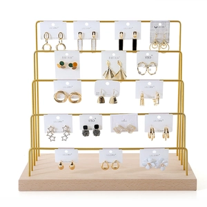 Five-tier gold metal jewelry organizer with wooden base for earrings and necklaces