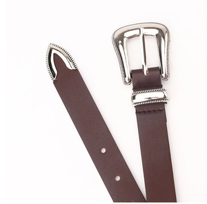 Close-up of vintage dark brown faux leather belt with ornate silver-toned alloy buckle