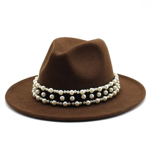 Detailed view of dark brown fedora hat featuring elegant triple-row pearl embellishments