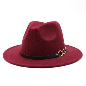 Detail of burgundy wool fedora featuring a black band and gold triple-link chain buckle