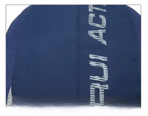 Macro shot of stitching details and breathable mesh fabric on navy blue baseball cap
